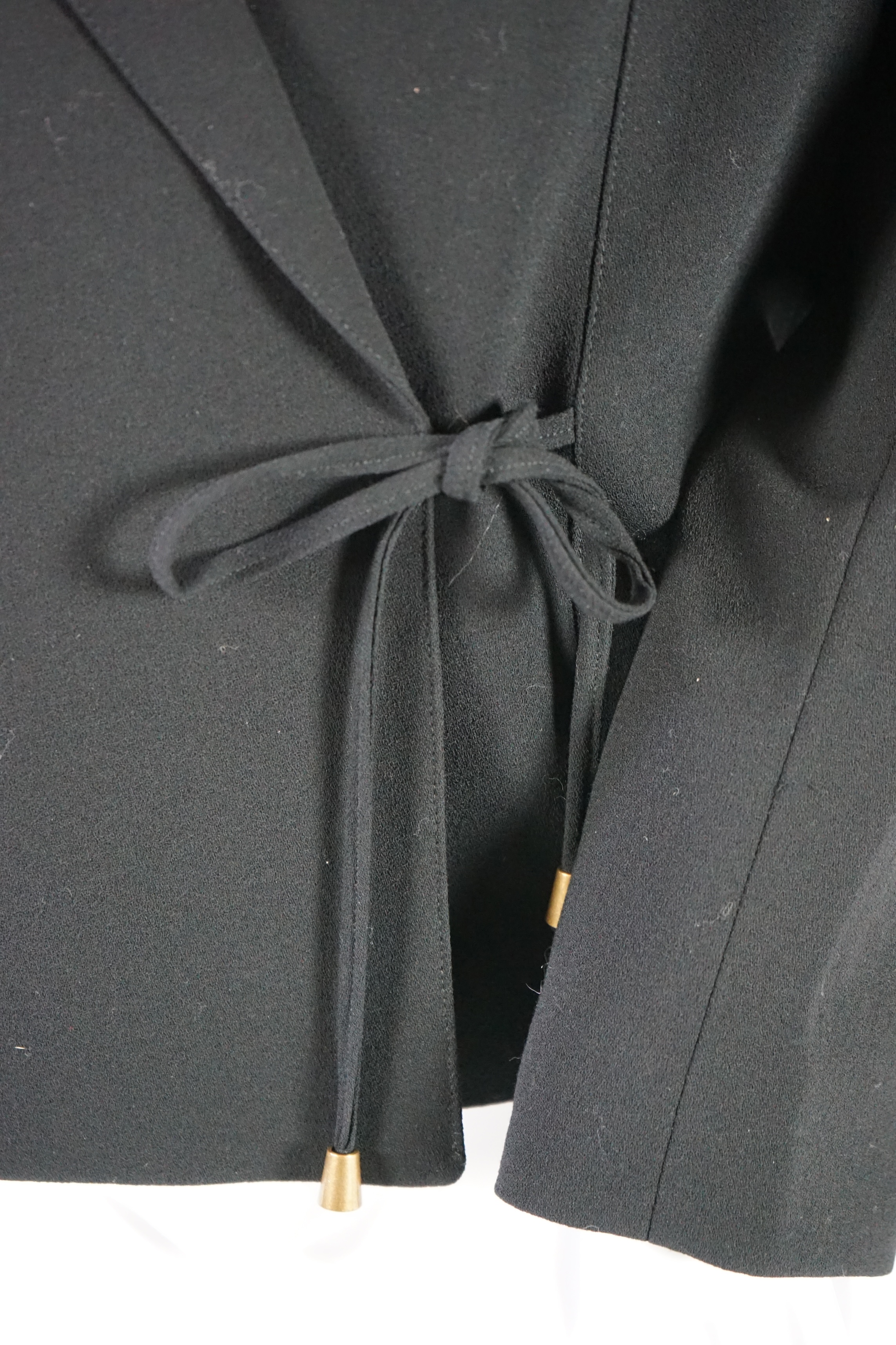 Two Louise Kennedy lady's suits: black with trousers and skirt, taupe long jacket with trousers. Approx size 14 Proceeds to Happy Paws Puppy Rescue